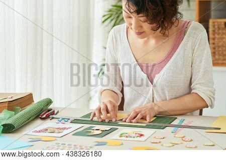 Woman Cutting Colored Paper