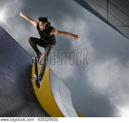 Skater doing kickflip on the ramp. Freestyle extreme sports concept