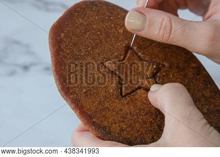 Kiev Ukraine - October 2021 Playing Korean Dalgona Or Ppopgi Honeycomb Candy From Squid Game Challen