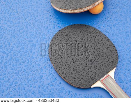 Ping-pong Paddles And Ball, That Were Left During The Rain. Table Tennis. Sports Equipment On The Pi