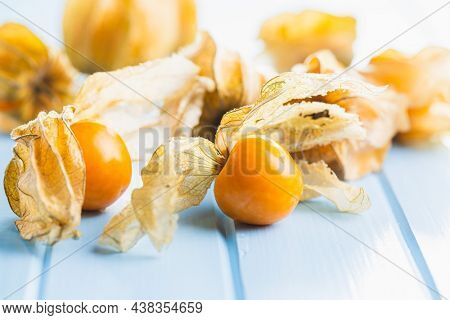 Physalis peruviana. Cape Gooseberry or ground cherries fruit on blue table.