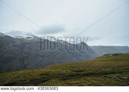 Minimalist Alpine Landscape With Snowy Mountains In Low Cloud In Overcast Weather. Deep Gorge On Bac