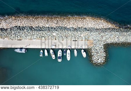 Aerial Drone View Of Fishing Boats Moored At The Harbor. Moored At Breakwater. Pyrgos Marina Cyprus 