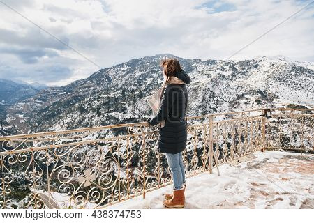 Back View Of Young Woman Standing At Mountain Top Observation Deck Over Vouraikos Gorge. Mega Spileo