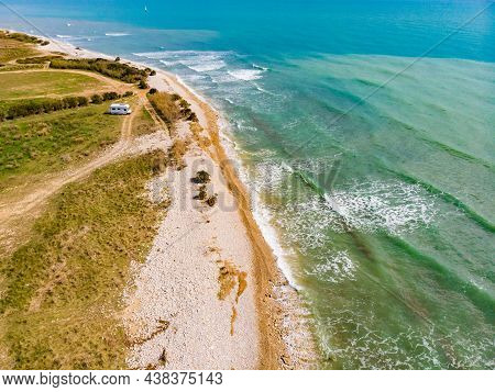 Aerial View. Coastal Landscape With Caravan Wild Camping On Beach Sea Shore. Mediterranean Coast Of 
