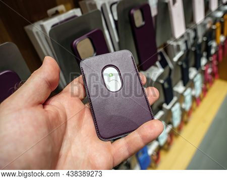 Paris, France - Sep 24, 2021: Pov Male Hand Holding In Apple Store New Iphone Leather Wallet With Ma
