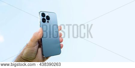 Paris, France - Oct 21, 2021: Male Hand Holding Latest Apple Computers Iphone 13 Pro With All Three 