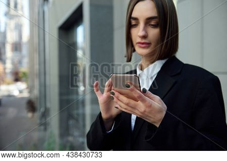 Lifestyle Portrait Of A Woman Freelancer, Motivated Young Successful Lady Holding And Holding A Mobi