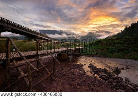 Beautiful Landscape Scenic Of The Wooden Bamboo Bridge With The Fog And Dramatic Sky Background In S