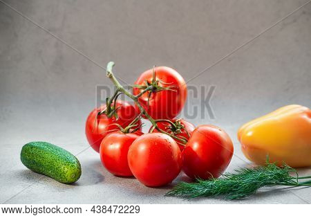 Tomato Branch, Cucumber And Yellow Pepper On Bright Background