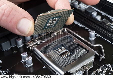 Electronic Engineer Installing Microprocessor. Maintenance Computer Cpu Hardware. Hand Holding A Com