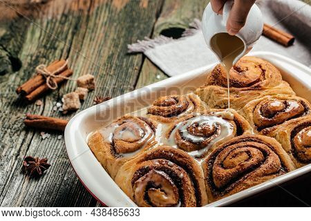 Homemade Cinnamon Rolls. Cinnamon Buns With Cream Sauce On Wooden Background. Top View.