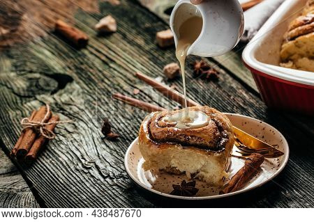 Baked Cinnamon Rolls With Cream Sauce. Food Recipe Background. Close Up.