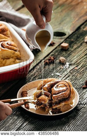 Cinnamon Sinnabon Bun, With Vanilla Creame On Wooden Background. Vertical Image. Top View. Place For