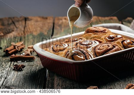 Cinnamon Sinnabon Bun, With Vanilla Creame On Wooden Background. Top View.