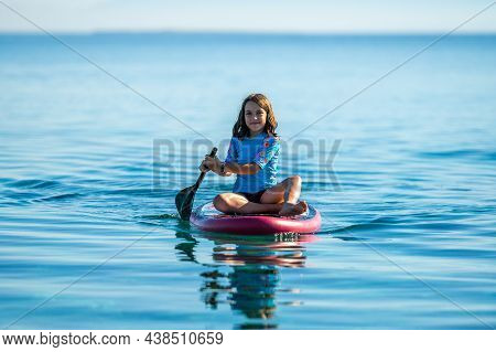 Child Girl Is Riding Sup Stand Up Paddle On Vacation.