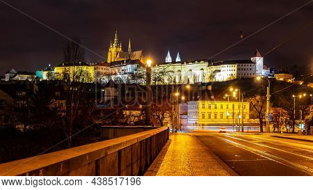 Night Tram In Prague. Motion Blurred Tram On Manes Bridge With Illuminated Prague Castle On Backgrou
