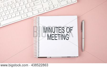 Pink Office Desk With Keyboard And Notebook , Text Minutes Of The Meeting