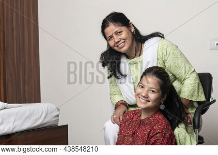 Portrait Of A Young Indian Girl Having Fun With Her Mother, Posing Towards The Camera With Her Mothe