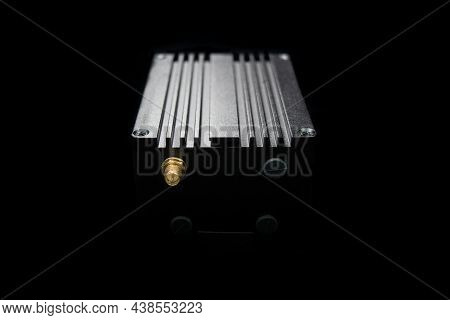 Helium Hotspot Cryptocurrency Miner Against A Black Backdrop
