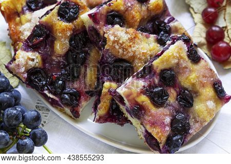Traditional Italian Yeast Dough Pie With Grapes Schiacciata And Bunches Of Grapes On A Light Backgro