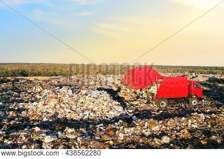 Landfill Waste Disposal. Garbage Dump With Waste Plastic And Polyethylene. Garbage Truck Unloads Rub