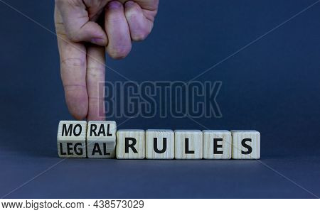 Legal Or Moral Rules Symbol. Businessman Turns Wooden Cubes And Changes Words 'legal Rules' To 'mora