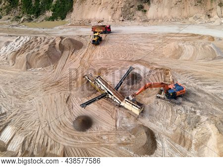 Arial View Of The Sand Open-pit Mining With Heavy Mining Machinery. Mobile Stone Jaw Crusher Machine