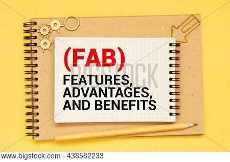 Business Acronym Fab - Feature Advantage Benefits. Text On A Sheet Of Notepad On A Black Envelope On