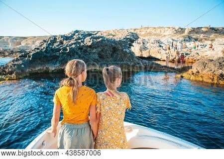 Little Girls Sailing On Boat In Clear Open Sea