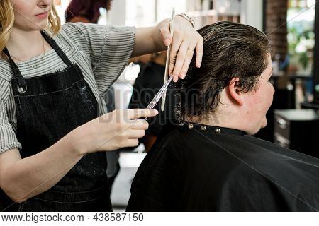 Customer getting a haircut in a beauty salon