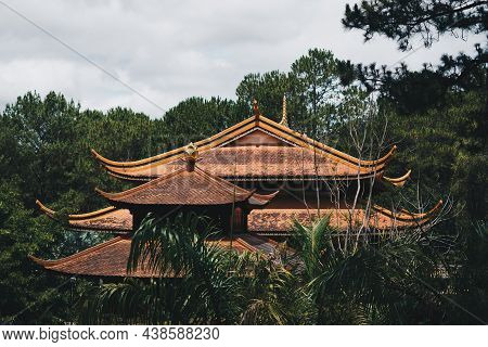 E Antique Red Brown Pagoda Multi Tiered Curved Roof Temple Buddhist. Pine And Palm Forest Day Sky Cl