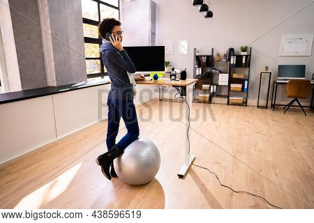 Adjustable Height Desk Stand In Office Using Computer