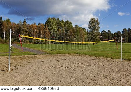 Umea, Norrland Sweden - September 2, 2021: Beach Volleyball Net By Large Grass Beds