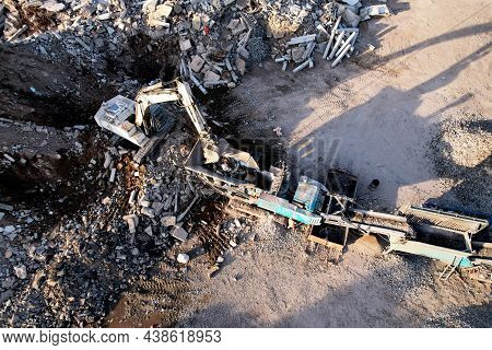 Excavator At Landfill The Load Concrete Waste In A Mobile Jaw Crusher Machine. Disposal Of Construct