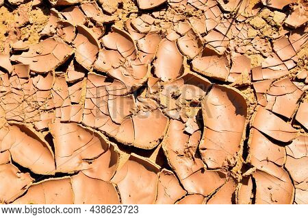 Cracked Soil Of The Earth Due To Climate Change. Dry Lake In The Process Of Drought And Lack Of Rain
