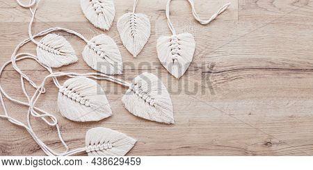 Macrame Leaves In Natural Color On The Wooden Background. Cotton Rope Decor Macrame To Make Your Hom