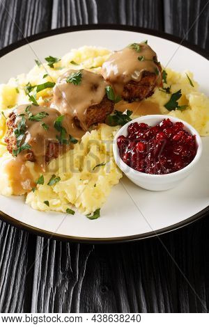 Finnish Meatballs With Gravy Served With Mashed Potatoes And Lingonberry Jam Close-up In A Plate On 