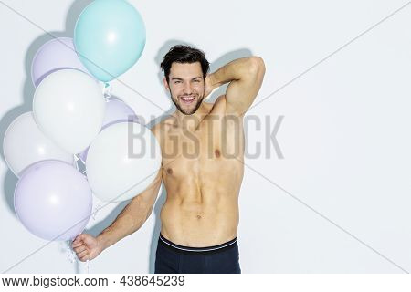 Celebrations Concepts. Funny Laughing Caucasian Handsome Brunet Man With Bunch Of Colorful Air Ballo