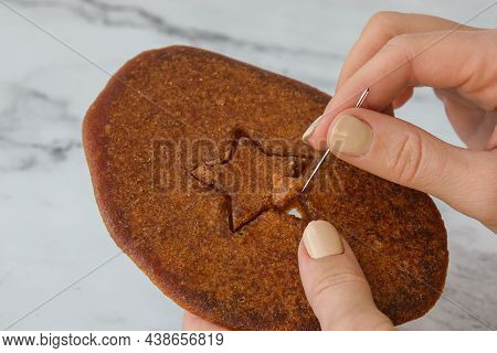 Kiev Ukraine - October 2021 Playing Korean Dalgona Or Ppopgi Honeycomb Candy From Squid Game Challen