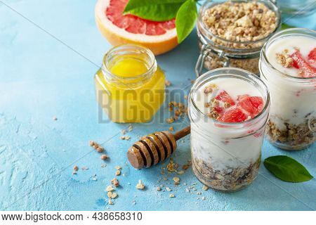 Vegan Healthy Breakfast. Granola With Greek Yogurt, Honey And Grapefruit In A Glass. Copy Space.