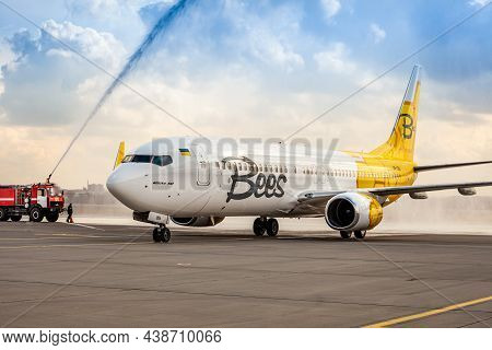 Bees Airline Yellow Plane On The Apron. Boeing 737-800 Ur-uba Passenger Aircraft. After Rain And Was