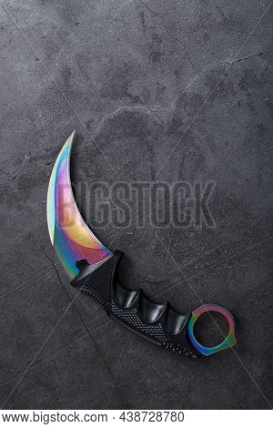 A Dagger With A Steel Blade With A Gradient Color On A Black Background.