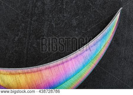 The Sharp Blade Of The Kerambit Knife Made Of Steel Is Multicolored In Close-up On A Dark Background
