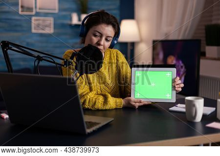 Social Media Influencer Talking With Fans Into Microphone Showing Mock Up Green Screen Chroma Key Ta