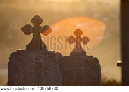 Headstones and grave sites in magic sunset at a cemtery