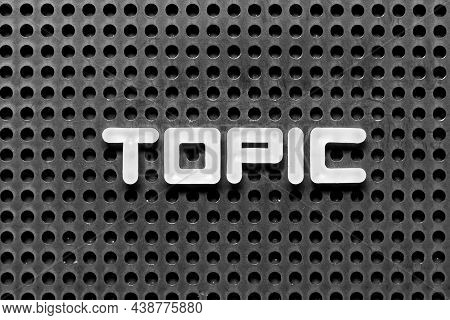 White Alphabet Letter In Word Topic On Black Pegboard Background