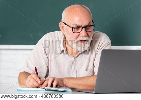 Elderly Education And Retired Knowledge Concept. Senior Teacher Teaching In The Classroom On Chalkbo