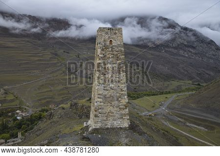 An Ancient Ossetian Battle Tower Against The Backdrop Of Foggy Mountains. Environs Of The Village Of