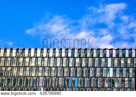 Reykjavik, Iceland - 6th October 2021: Detail of the glass facade of the Harpa Hall, Reykjavik. The concert and conference venue is built to mirror the geometric basalt columns of Iceland